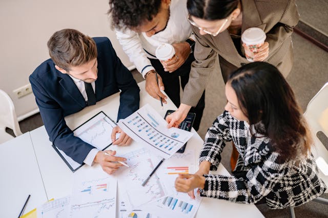 group of people looking at graphs